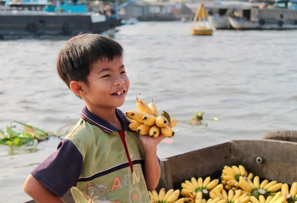 Little boy selling bananas