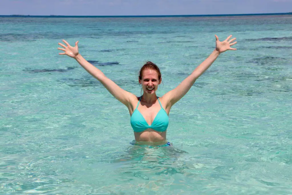 Gwen on the Sandbar. Don't forget to add a bathing suit to your packing list for Belize.