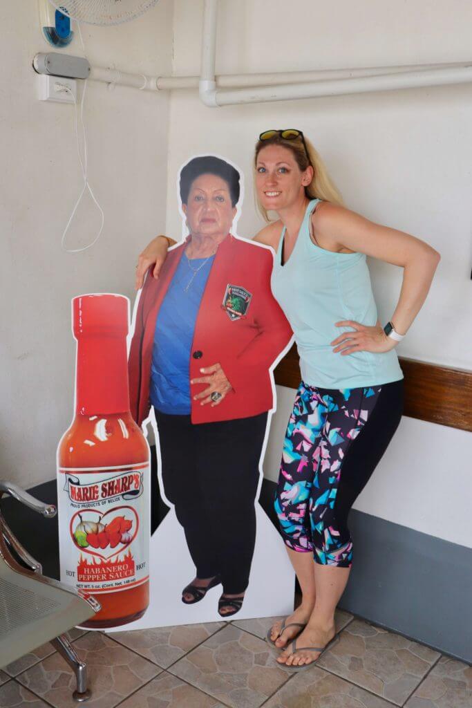 Brooke posing with a cardboard cutout of Marie Sharp, whose delicious hot sauces we loved during our week in Belize