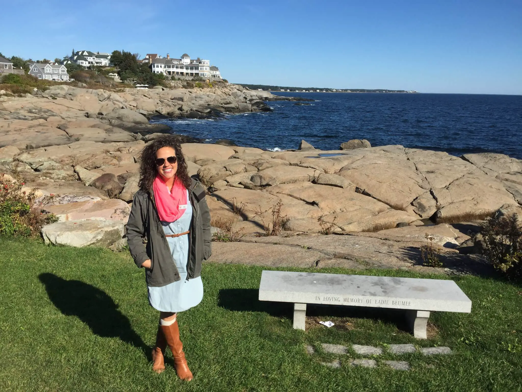 Emily in front of a rocky New England coastline
