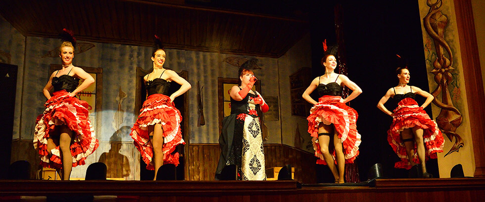 Can-can dancers with Gertie. Visiting Diamond Tooth Gertie's is a great way to give back while you travel through the Yukon.