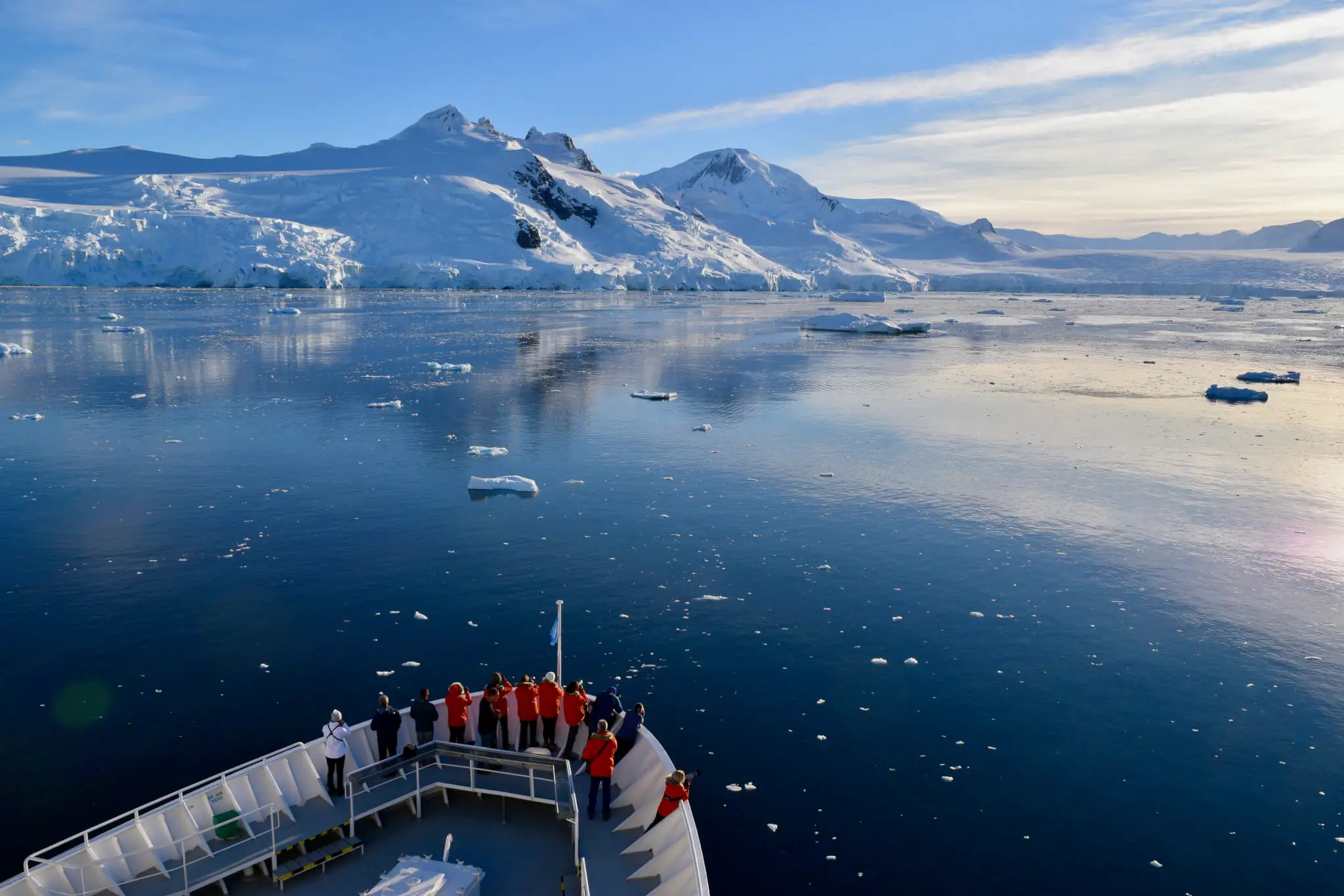 front of ship cruising through icebergs