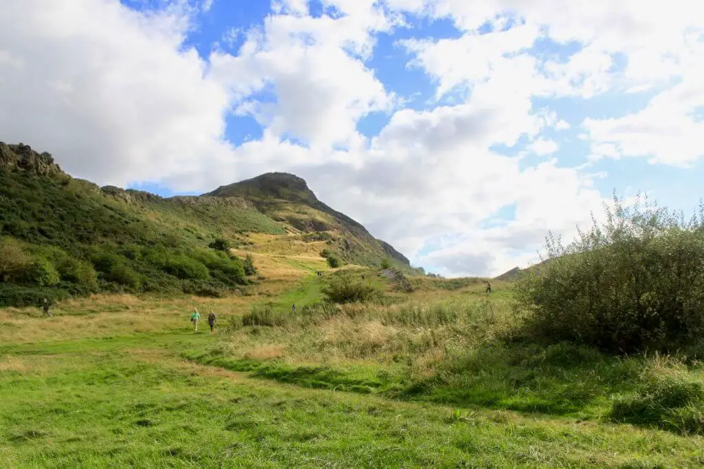grassy parkland with Arthur's Seat in distance