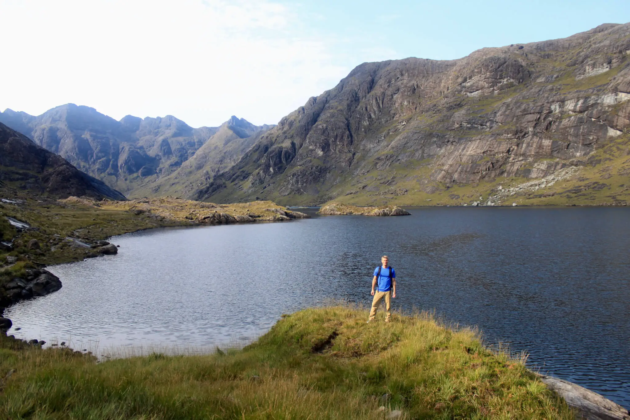 M standing in front of Loch Coruisk with mountains beyond
