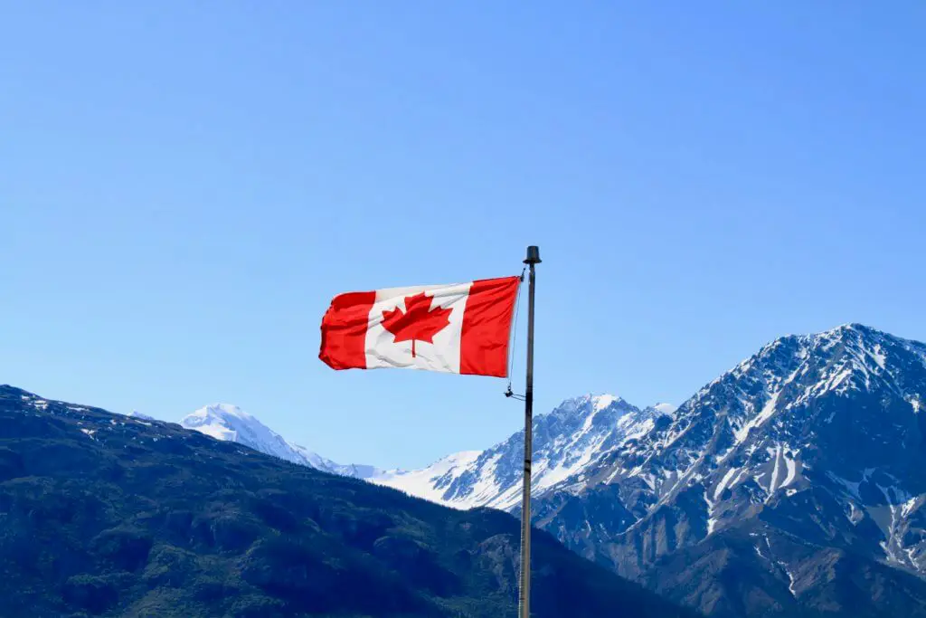 Canadian flag with mountains behind