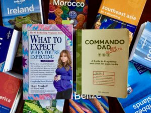 Parenting books on top of Lonely Planet travel guidebooks
