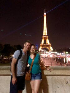 Gwen and M in front of the Eiffel Tower at night