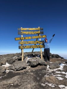 Michelle at the summit of Mt. Kilimanjaro in Tanzania