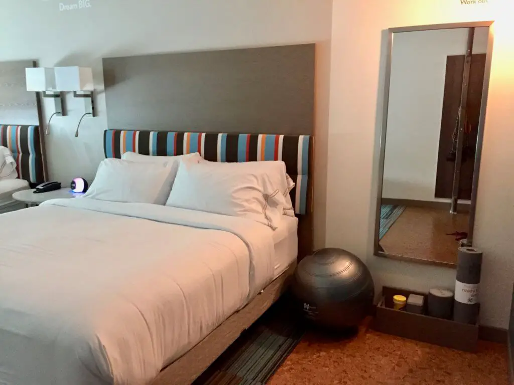 Exercise equipment next to hotel bed