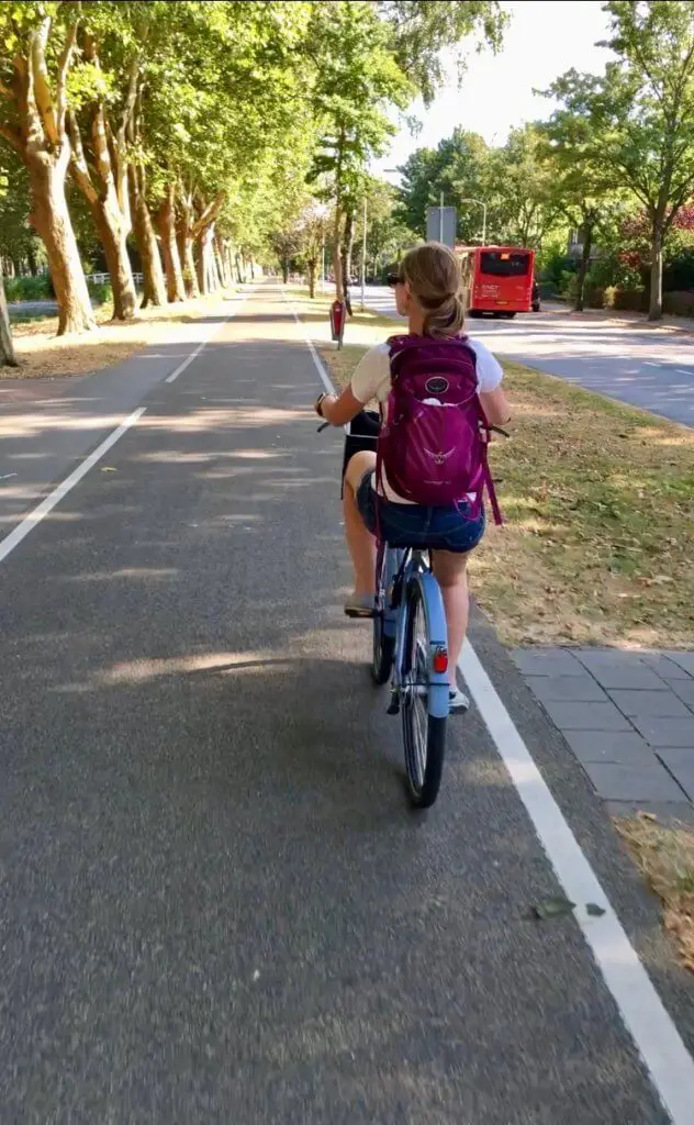 Gwen biking on bike path - a great way to stay healthy while traveling!