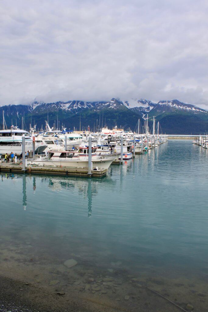 Boats in the marina in Seward, Alaska, with mountains behind