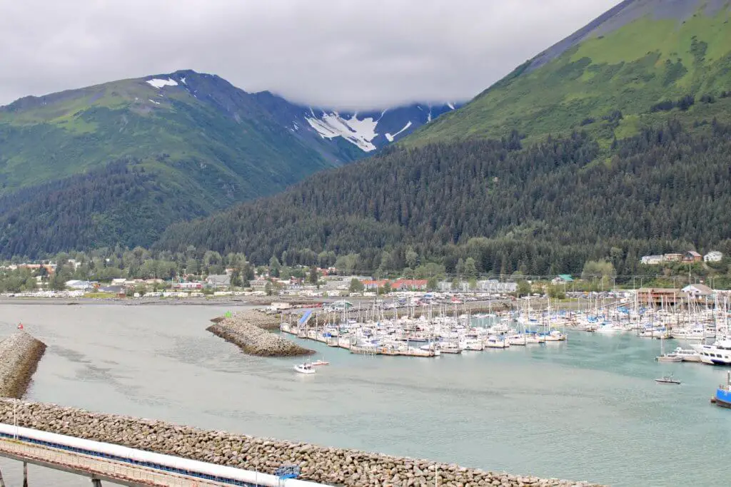 Cloudy view of the marina and town of Seward, Alaska. Don't forget to add a waterproof jacket to your Alaska packing list!