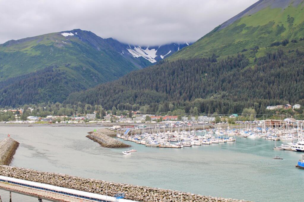 Cloudy view of the marina and town of Seward, Alaska. Don't forget to add a waterproof jacket to your Alaska packing list!