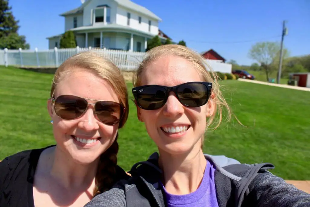 Molly and Gwen in front of the white Field of Dreams farmhouse