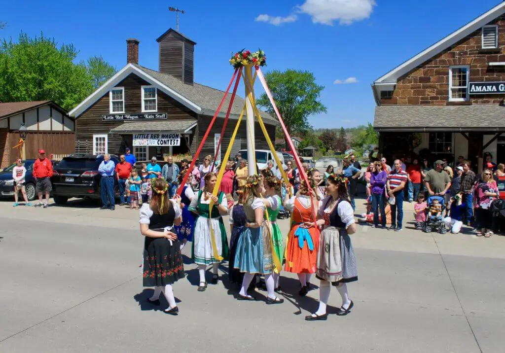 Women dancing around a maypole in traditional dress