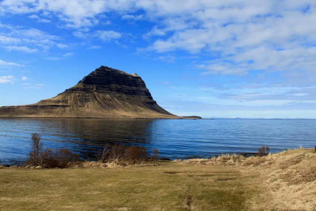 Kirkjufell with blue sky and water