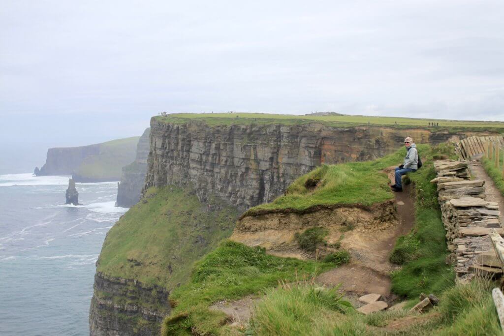 Papa M sitting along the Cliffs of Moher
