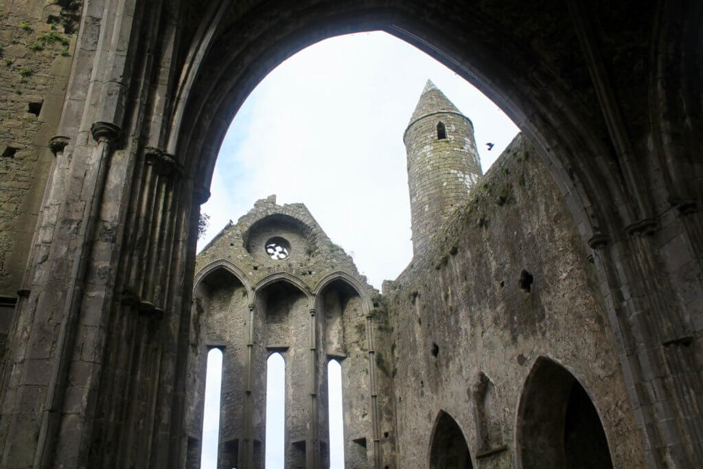 Interior of Rock of Cashel - stone cathedral walls with no roof open to the sky