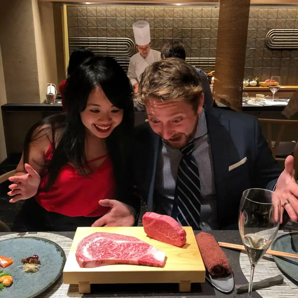 Erica and Jeff staring excitedly at a cut of Kobe beef