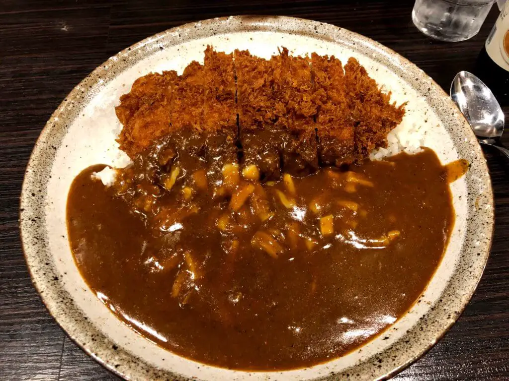 Crispy pork katsu with white rice and brown sauce