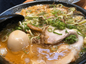 Close-up of a Japanese ramen dish with egg, noodles, and meat