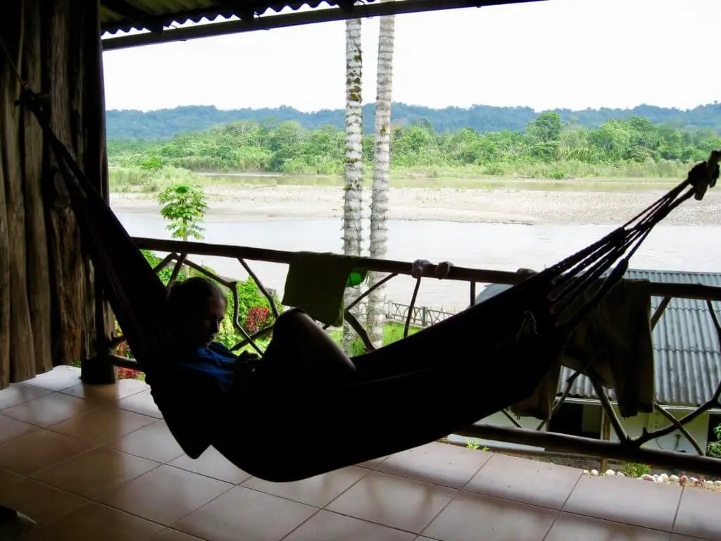Gwen silhouetted in a hammock with the river and jungle behind