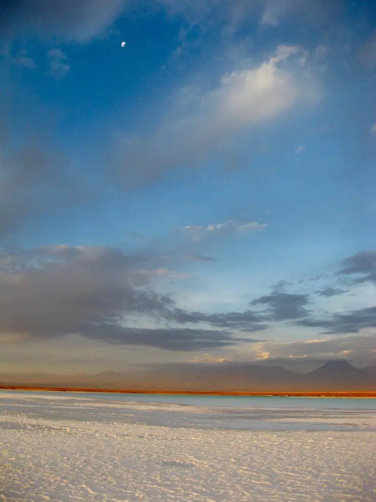 half-moon above the salt flats of the Salar de Atacama