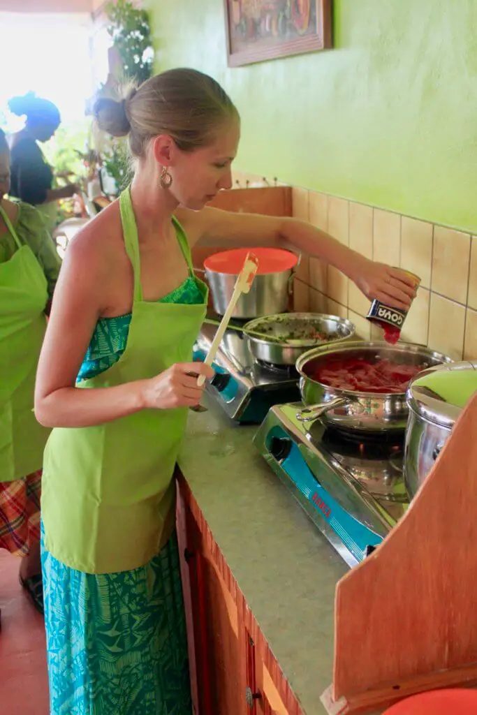 Gwen adding ingredients to the fish stew
