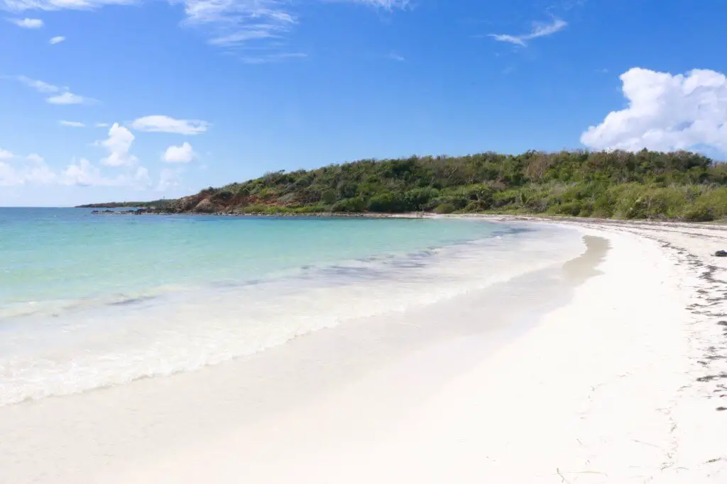 Half-moon shaped La Plata beach on Vieques with white sand and teal water