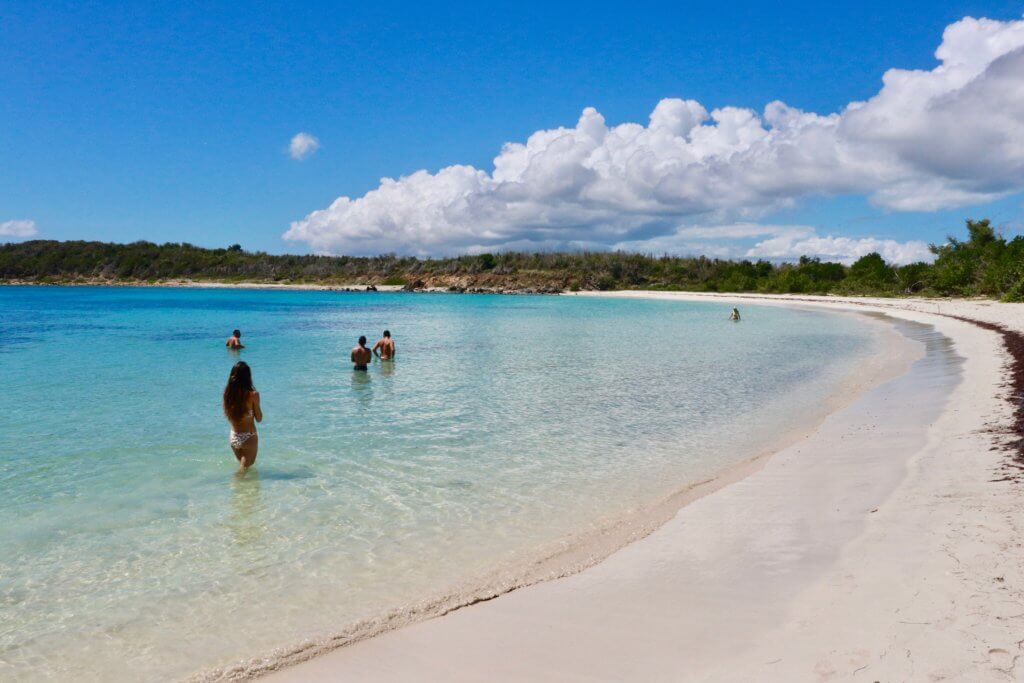 People wading in teal water at Pata Prieta