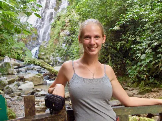 Gwen standing in front of a waterfall in Panama