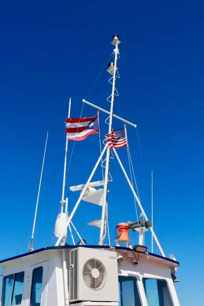 Puerto Rican and American flags fluttering in the breeze atop the Vieques ferry