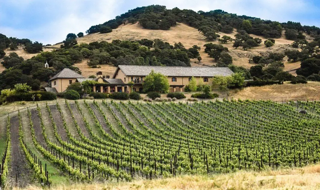 Vineyard and building with hills beyond. California's wine country makes an excellent mother-daughter trip destination.