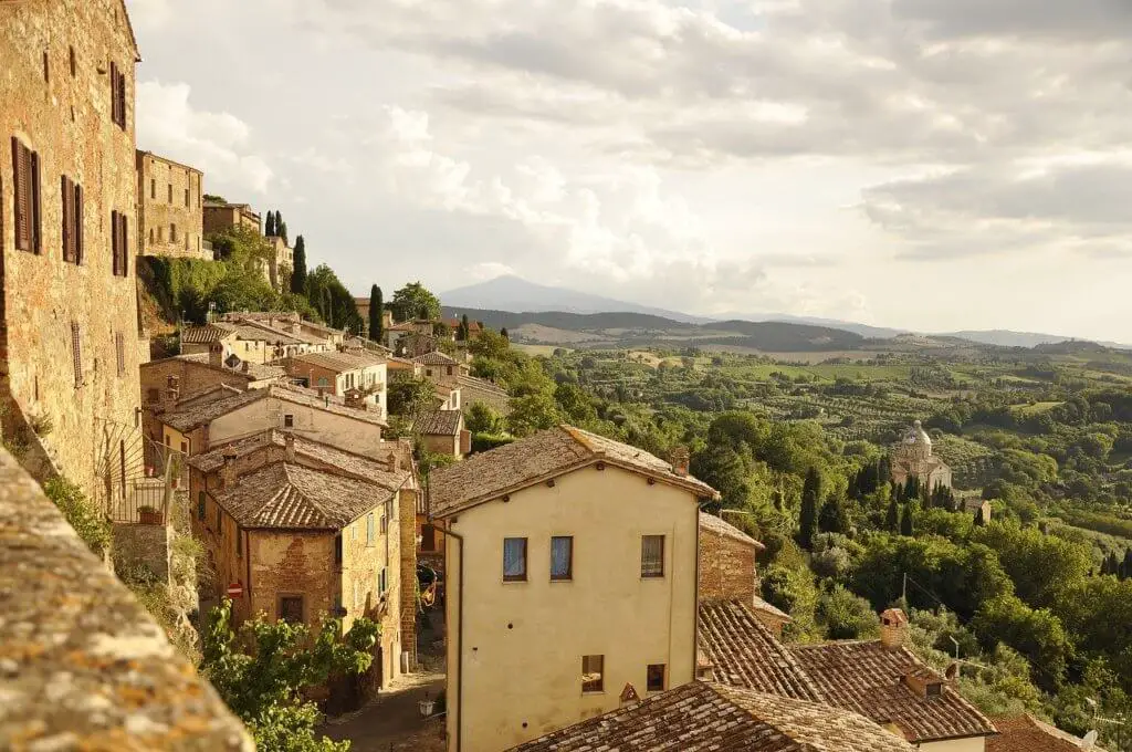 Charming old Italian village on a hillside with Tuscan countryside beyond