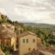 Charming old Italian village on a hillside with Tuscan countryside beyond