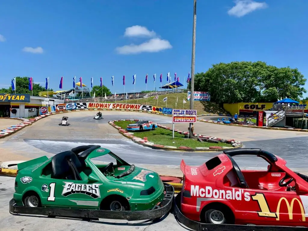 Two go-karts speeding around Midway Speedway