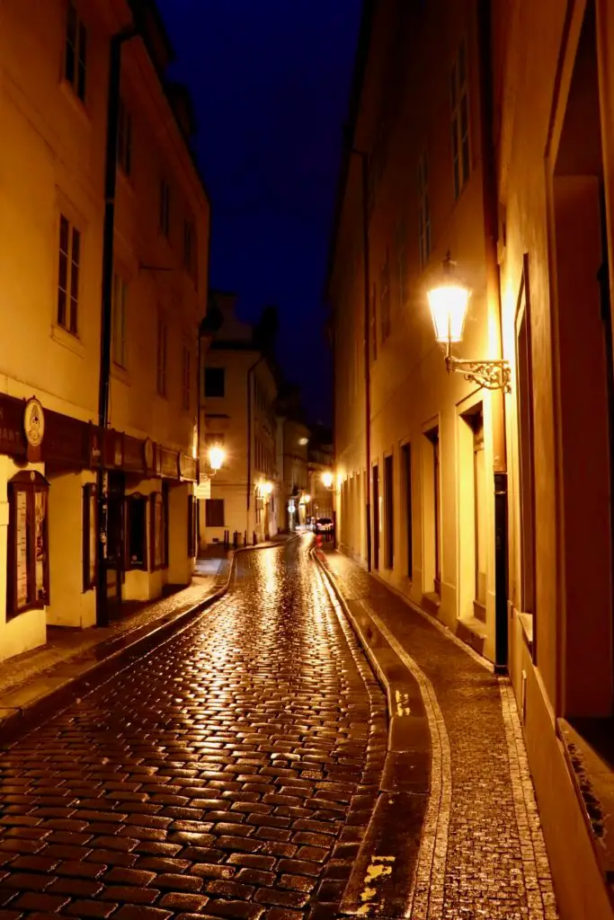 The empty, lamplit streets of Prague on the way to the Charles Bridge