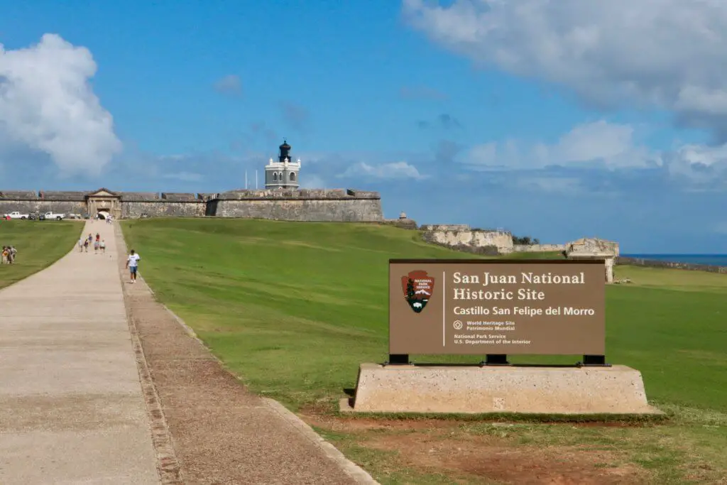 View of Castillo San Felipe del Morro park service sign with fort beyond