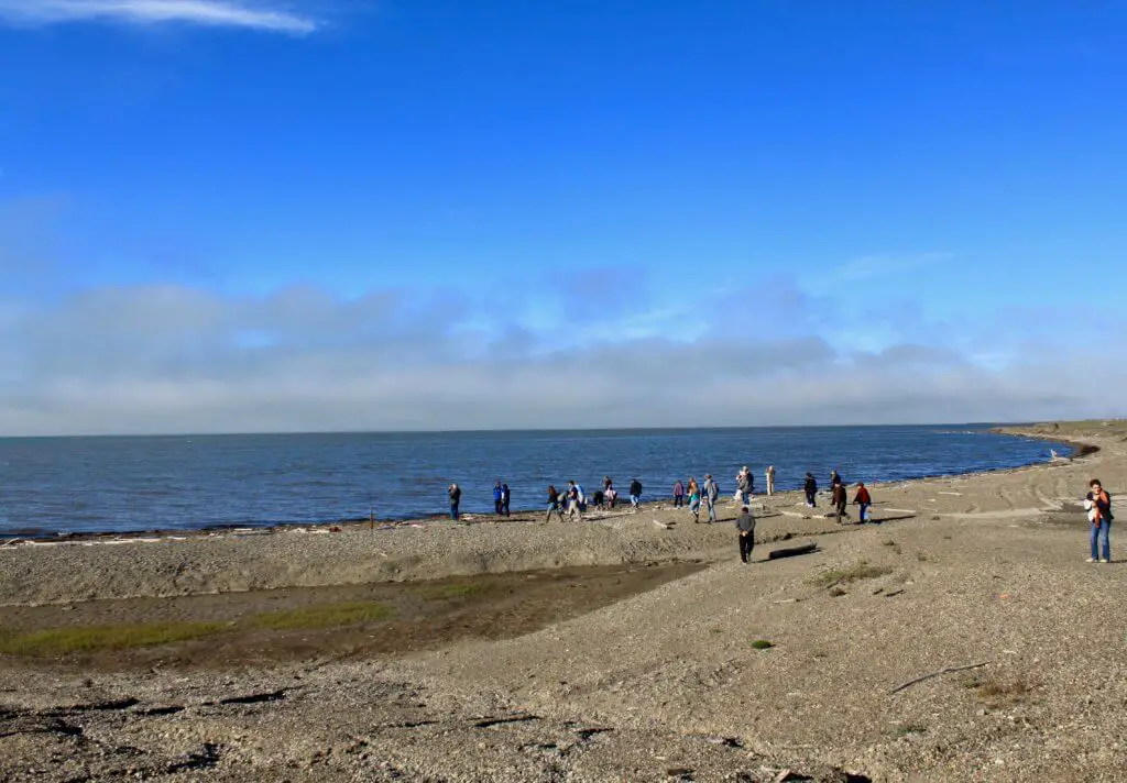 People gathered on the shoreline of the Arctic Ocean