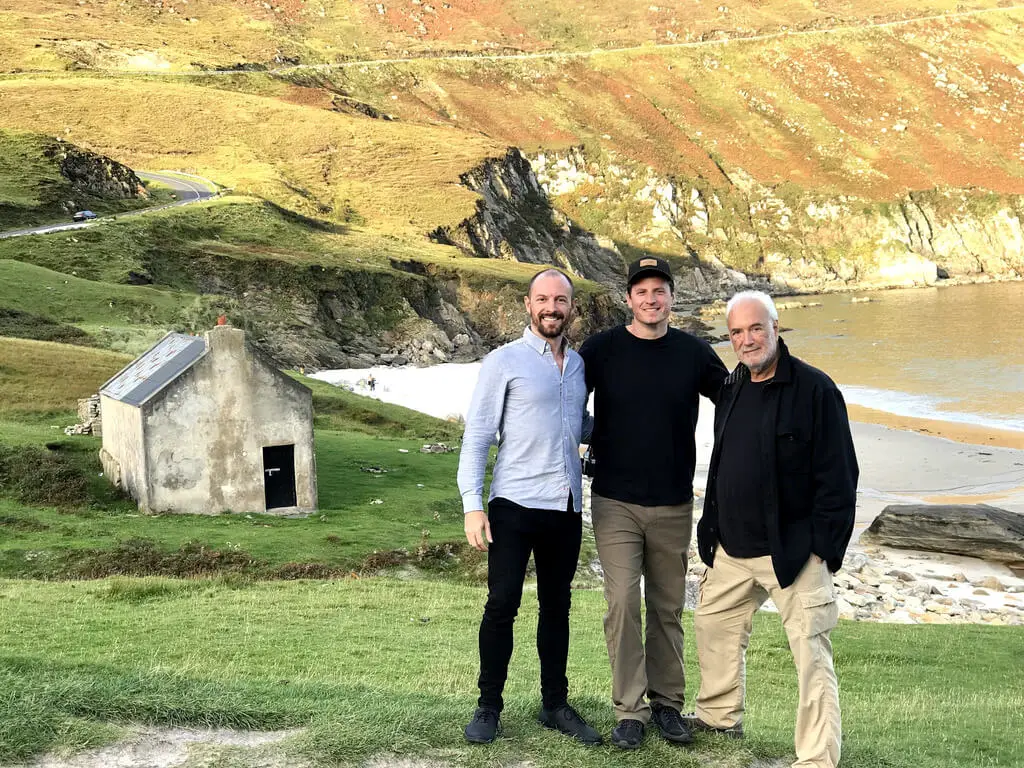 Max with his brother and dad along the rocky Irish coastline
