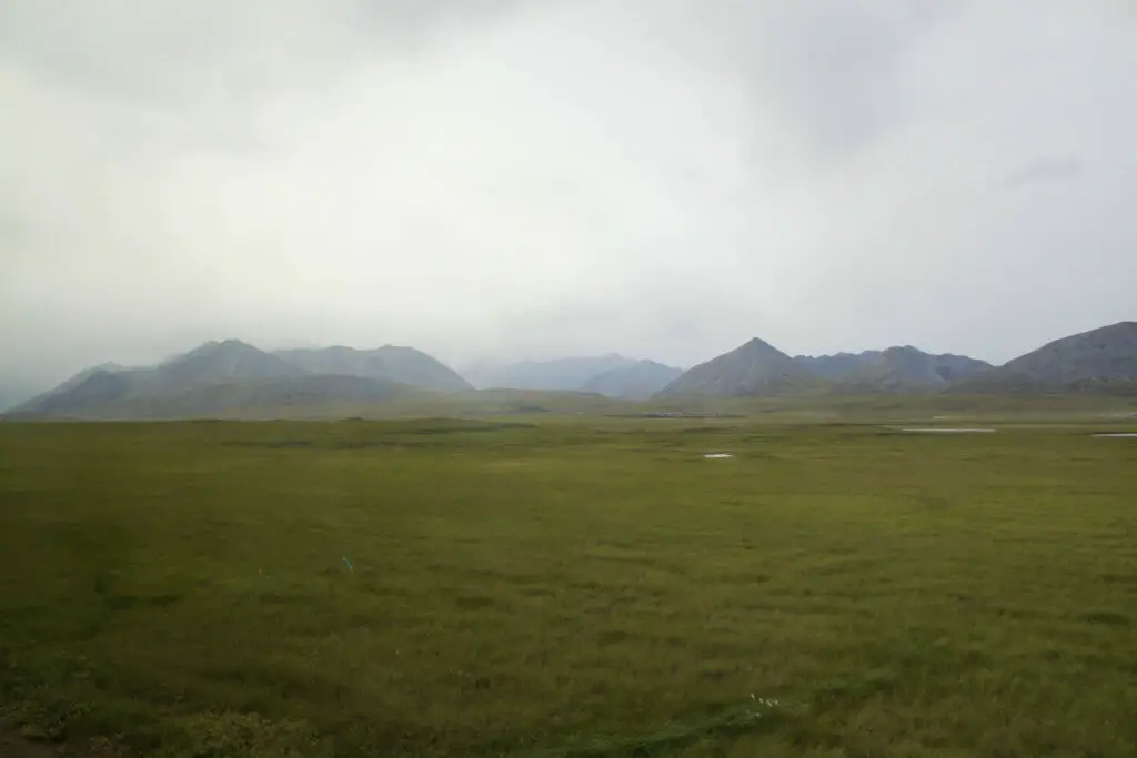 Foothills of the Brooks Range shrouded in clouds as seen from the Dalton Highway in Alaska