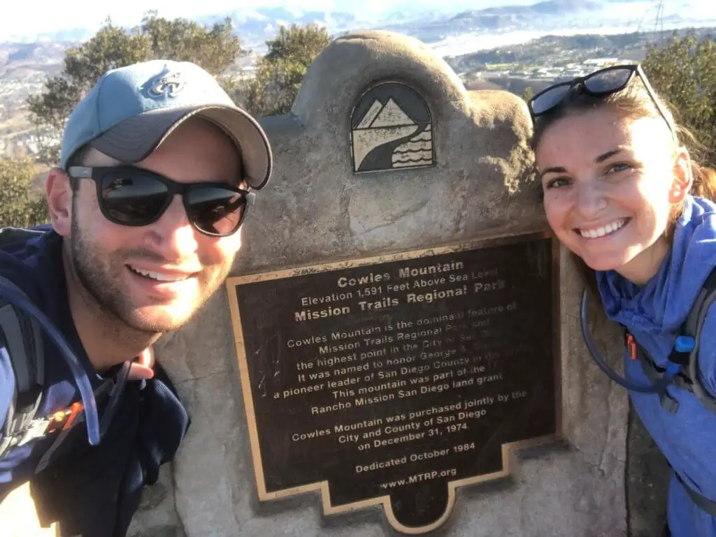 Chad and Charlotte in front of a Cowles Mountain plaque - doing another of the best hikes in San Diego!