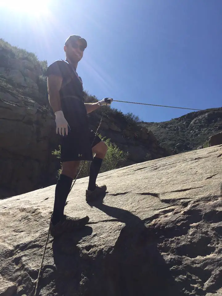 Chad using ropes to assist with the climb
