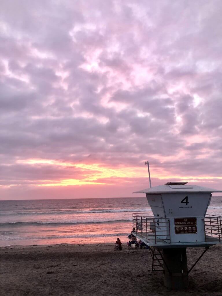 Lifeguard tower looking out over a pink sunset
