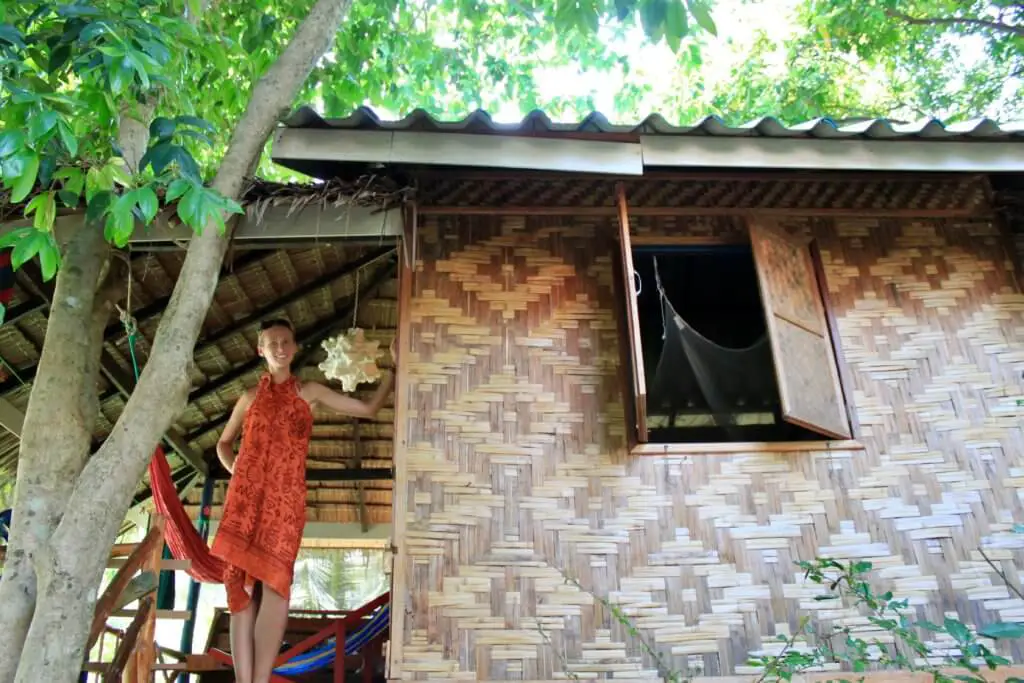 Gwen in front of her beach bungalow in Thailand