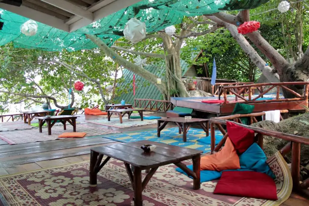 Lounge and restaurant area at Treehouse with low tables and colorful cushions