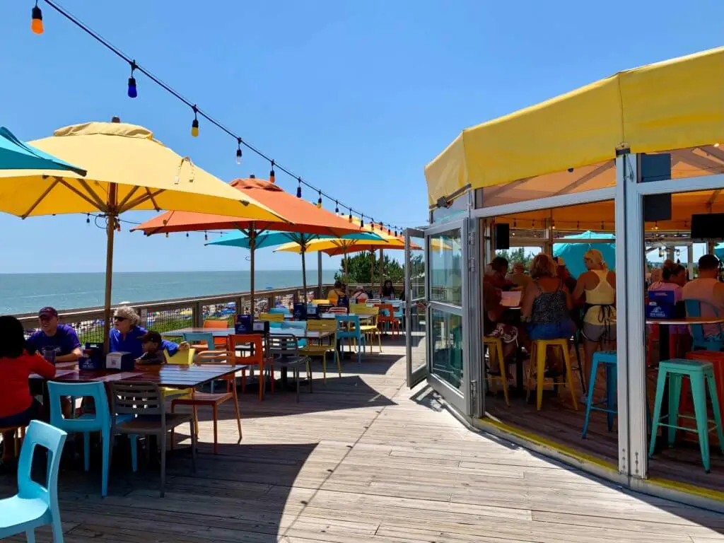 Top deck at the Big Chill Beach Club, with colorful umbrellas and chairs and ocean beyond