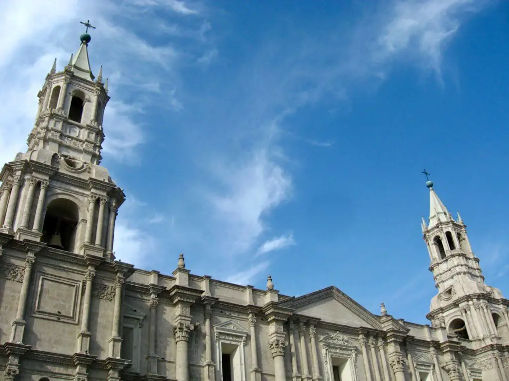 The white cathedral towers of Arequipa against a bright blue sky