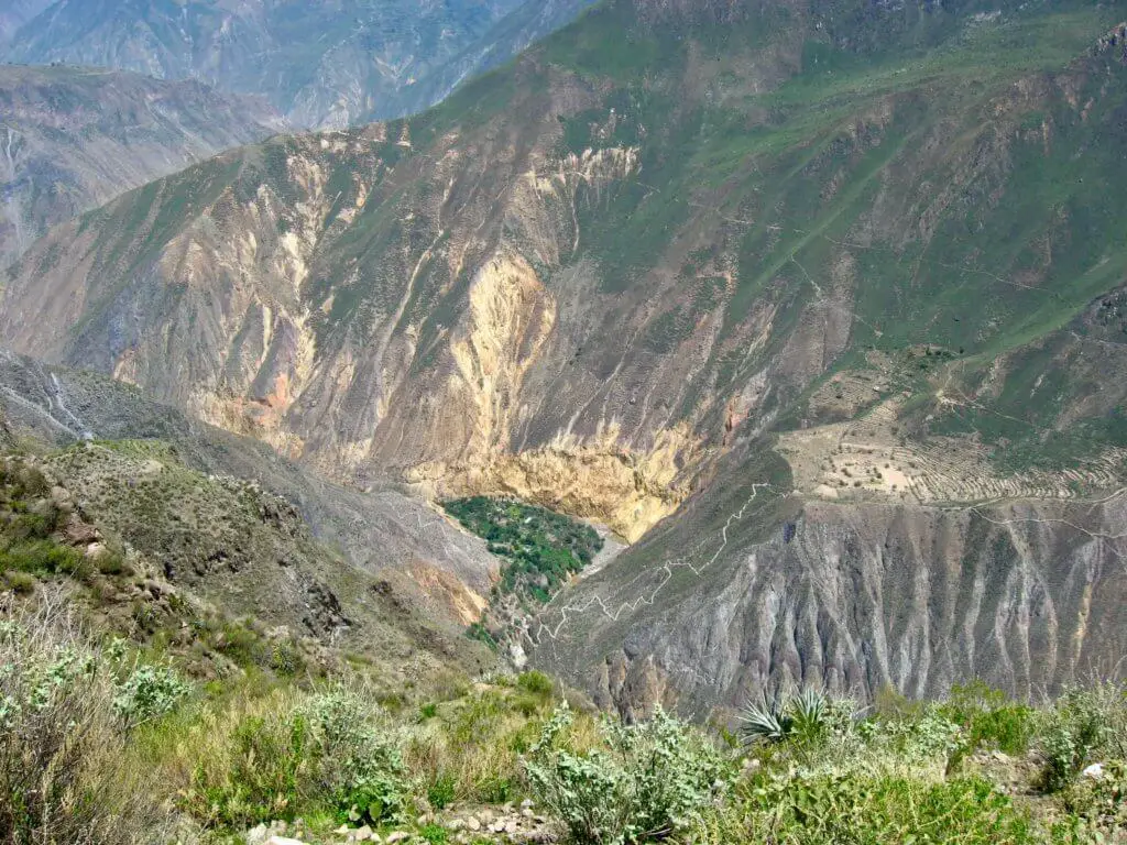 Looking down into Colca Canyon at a green oasis below