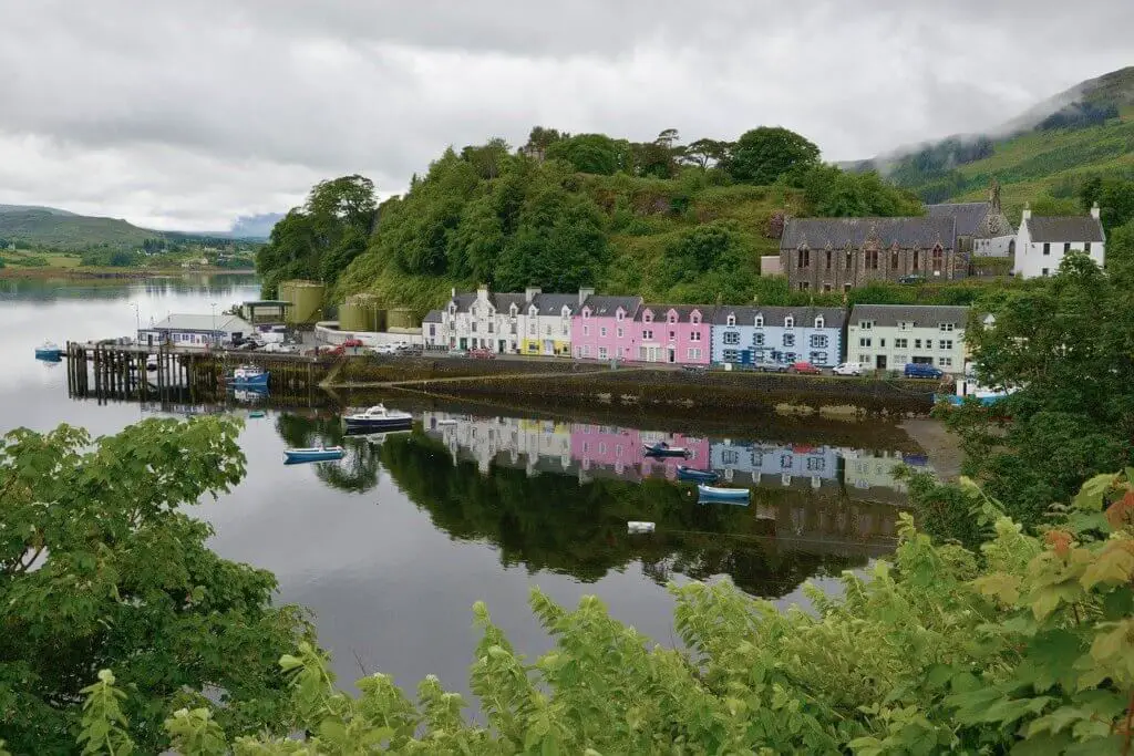 Colorful buildings along the harbor in Portree, the first stop on this driving itinerary for the Isle of Skye